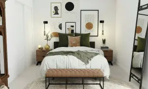 Habitación pequeña con cama grande, decorada con arte abstracto y cojines verdes. Un banco de terciopelo marrón al pie de la cama.