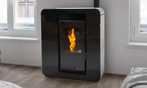 Estufa de pellets moderna con llama encendida. Instalación estufa pellets en un salón acogedor junto a la ventana.
