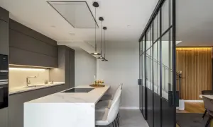 Cocina moderna con isla, campana extractora empotrada en el techo y diferentes tipos de campanas extractoras visibles.