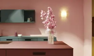 Elegante cocina con encimeras y armarios en tonos rosados y verde azulado. Un jarrón con flores rosas ilumina el espacio, creando una hermosa **combinación de colores para cocina**.