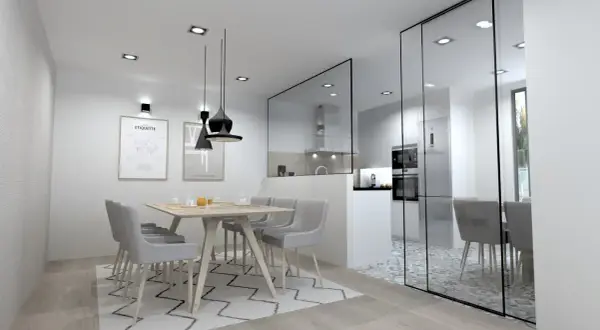 Comedor moderno con **cocina semiabierta cristal**. Mesa de madera con sillas grises, alfombra geométrica y cocina visible tras panel de cristal.
