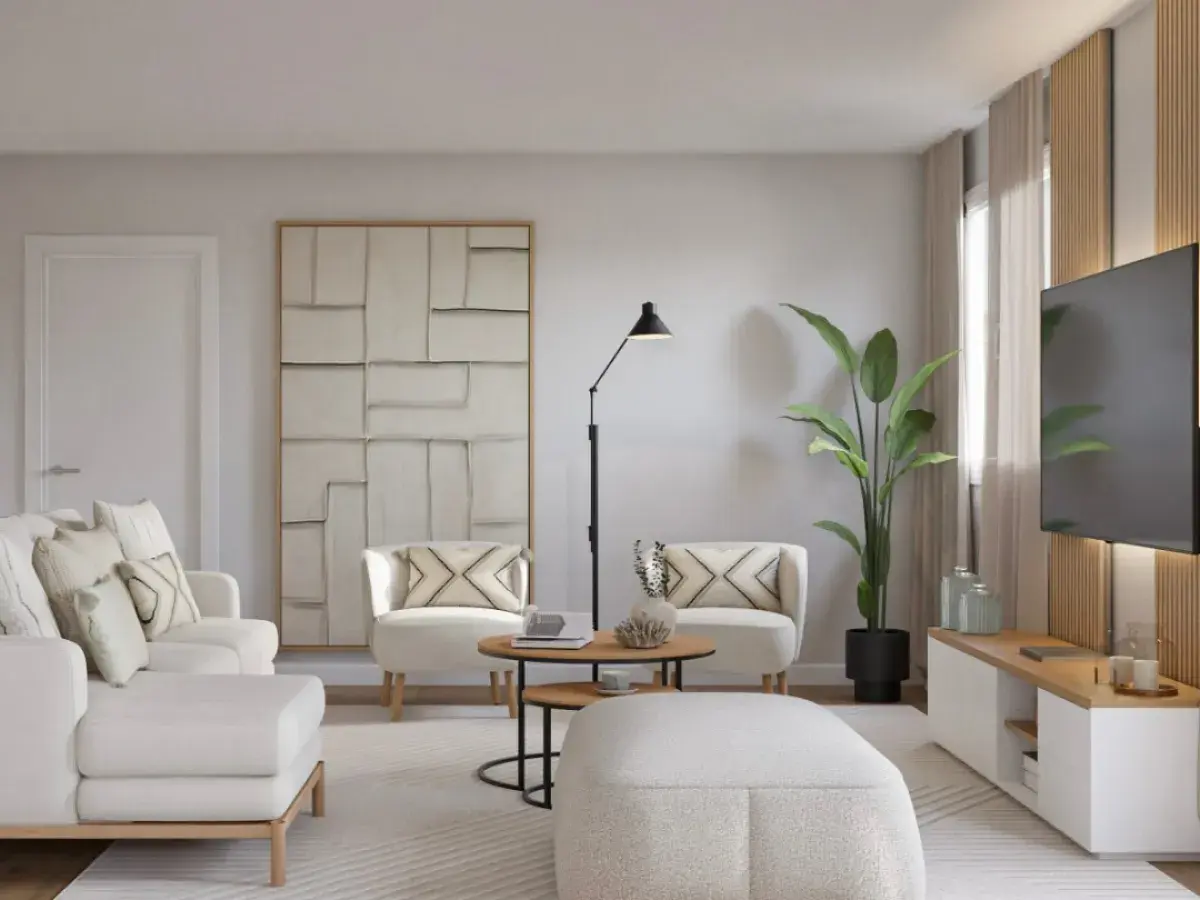 Un salón moderno y luminoso, ideal para aprender como decorar un salón con muebles blancos. Sofá, sillones y pouf blancos, con detalles en madera y arte abstracto.