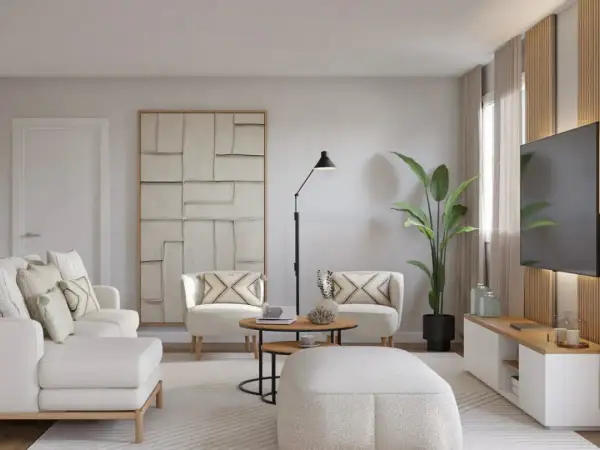 Un salón moderno y luminoso, ideal para aprender como decorar un salón con muebles blancos. Sofá, sillones y pouf blancos, con detalles en madera y arte abstracto.